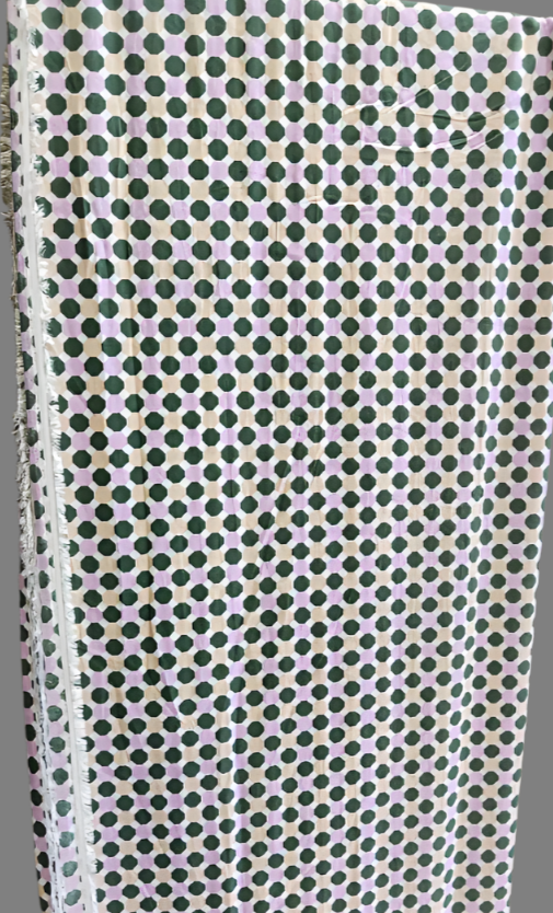 Fabric with a pattern of small green and pink dots