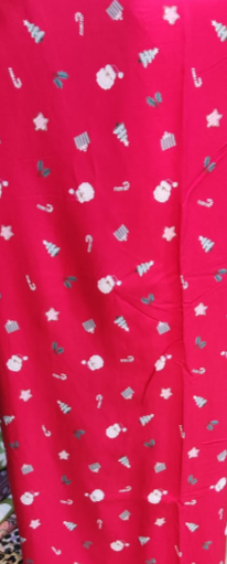 Red fabric with white Christmas-themed patterns