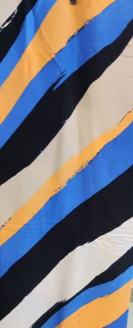 Striped fabric with blue, orange, and black pattern on a plain background