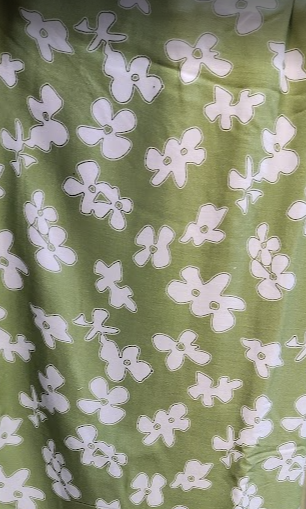 Green fabric with white floral pattern