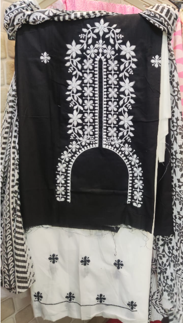 Black and white embroidered garment on a hanger