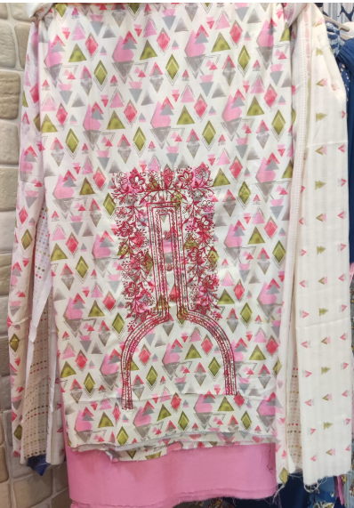 Patterned fabric with pink and green geometric design on a white background