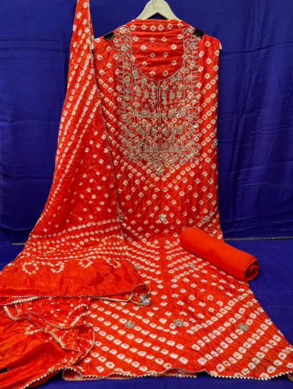 Orange embroidered traditional outfit with a blue background